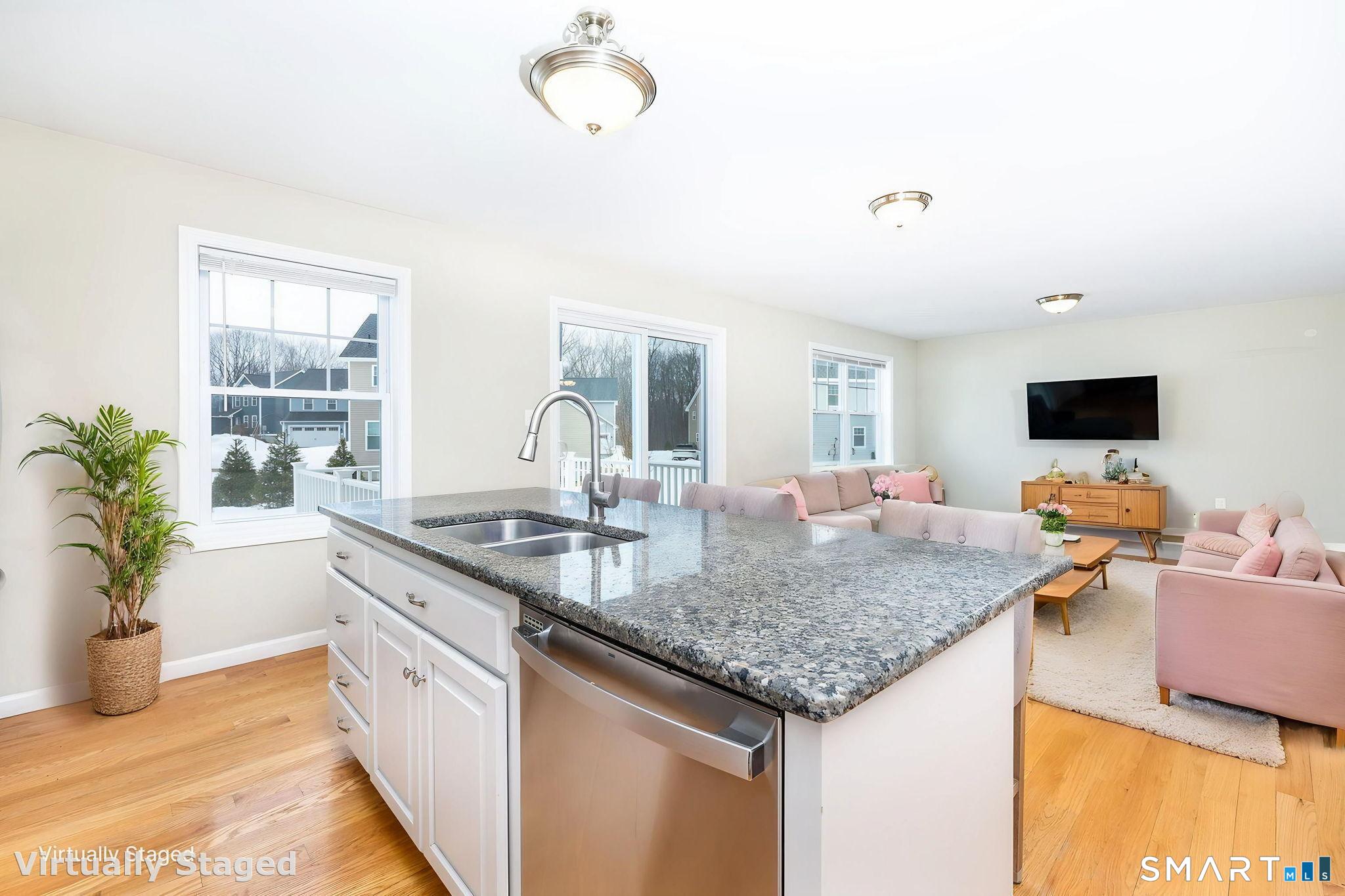 365 Allentown Road, Unit 34 Bristol, CT 06010 - Photo 13 of 43 a kitchen with stainless steel appliances granite countertop a sink dishwasher and a microwave with wooden floor