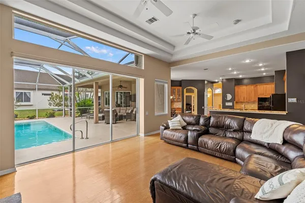a living room with furniture and a floor to ceiling window