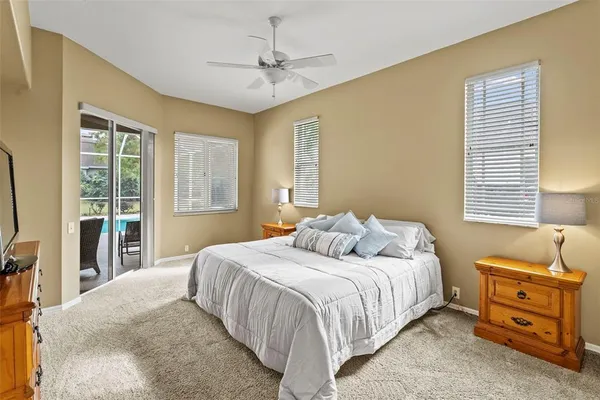 a bedroom with a bed window and a flat screen tv