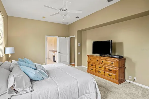 a bedroom with furniture and a flat screen tv