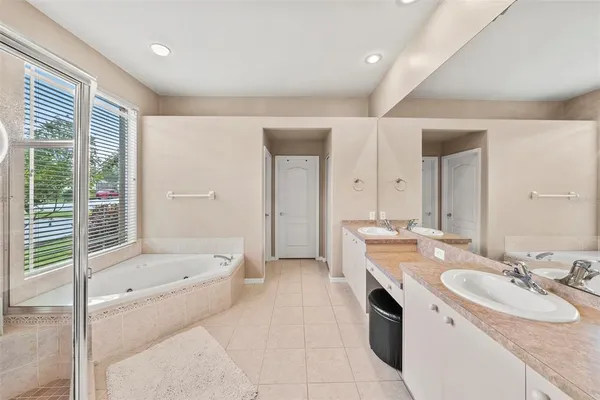 a bathroom with a double vanity sink and a mirror