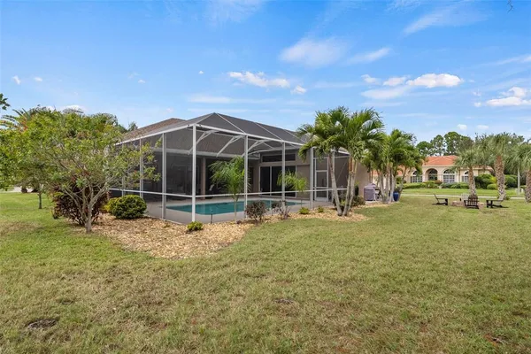 a view of a backyard with a slide trees and wooden fence