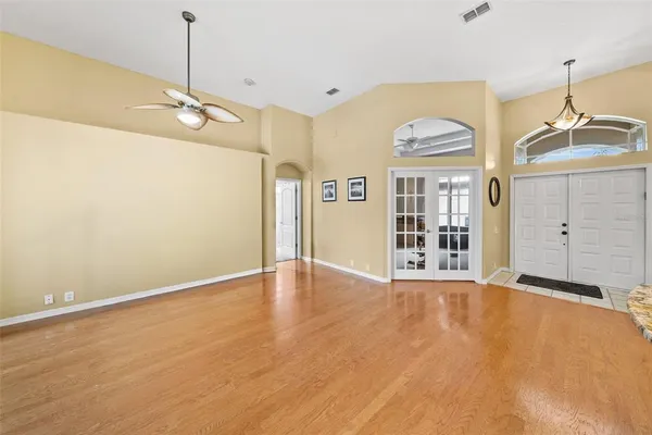 a view of a livingroom with a furniture wooden floor a chandelier