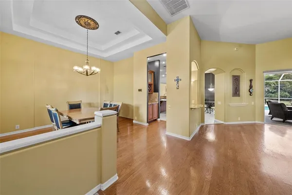 a view of kitchen with kitchen island granite countertop sink refrigerator and microwave