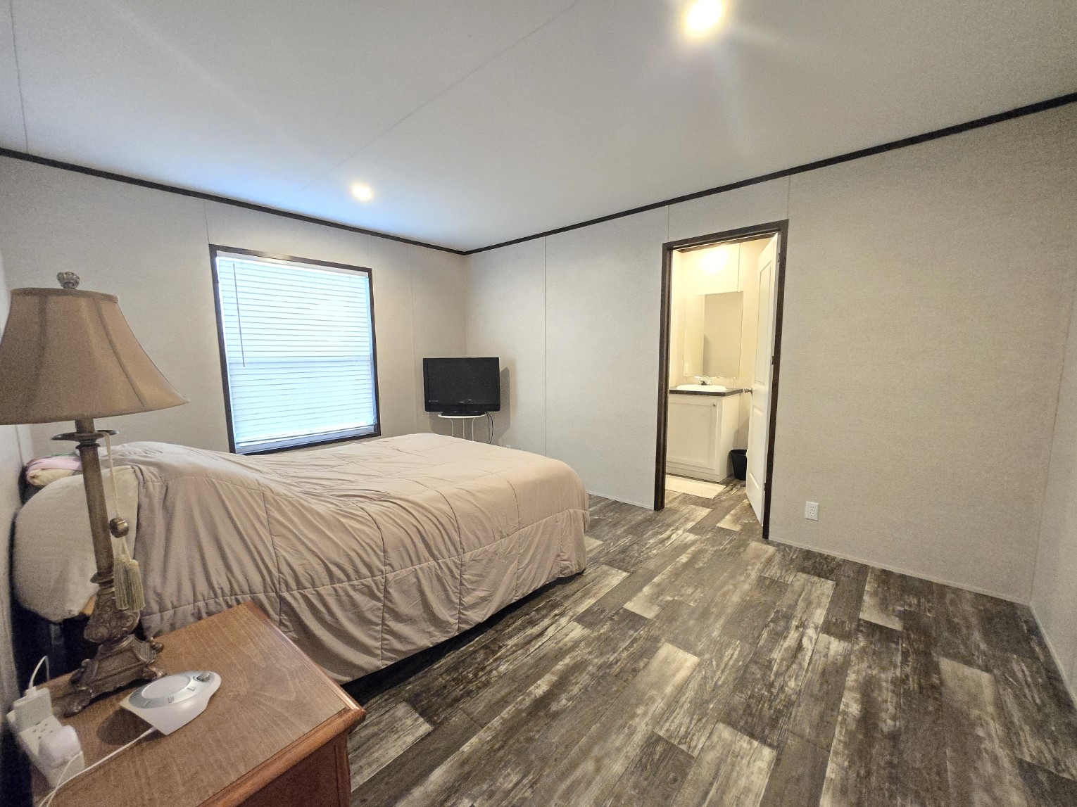 221 Old Waelder Road Flatonia, TX 78941 - Photo 23 of 27 a bedroom with a bed and a lamp on dresser