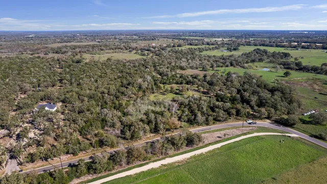 an aerial view of a houses with a yard