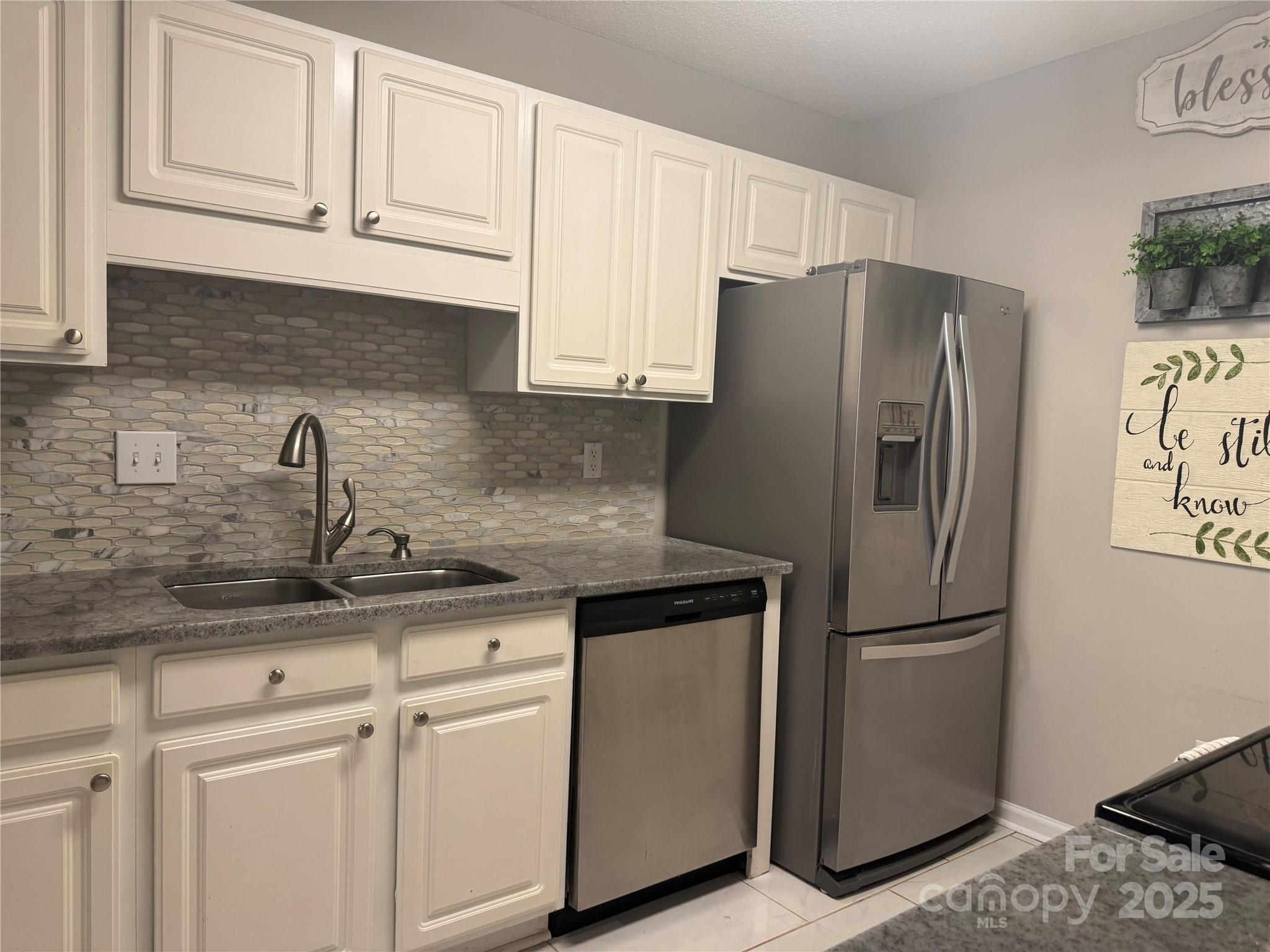 21120 Cold Spring Lane Cornelius, NC 28031 - Photo 12 of 22 a kitchen with appliances a sink and cabinets