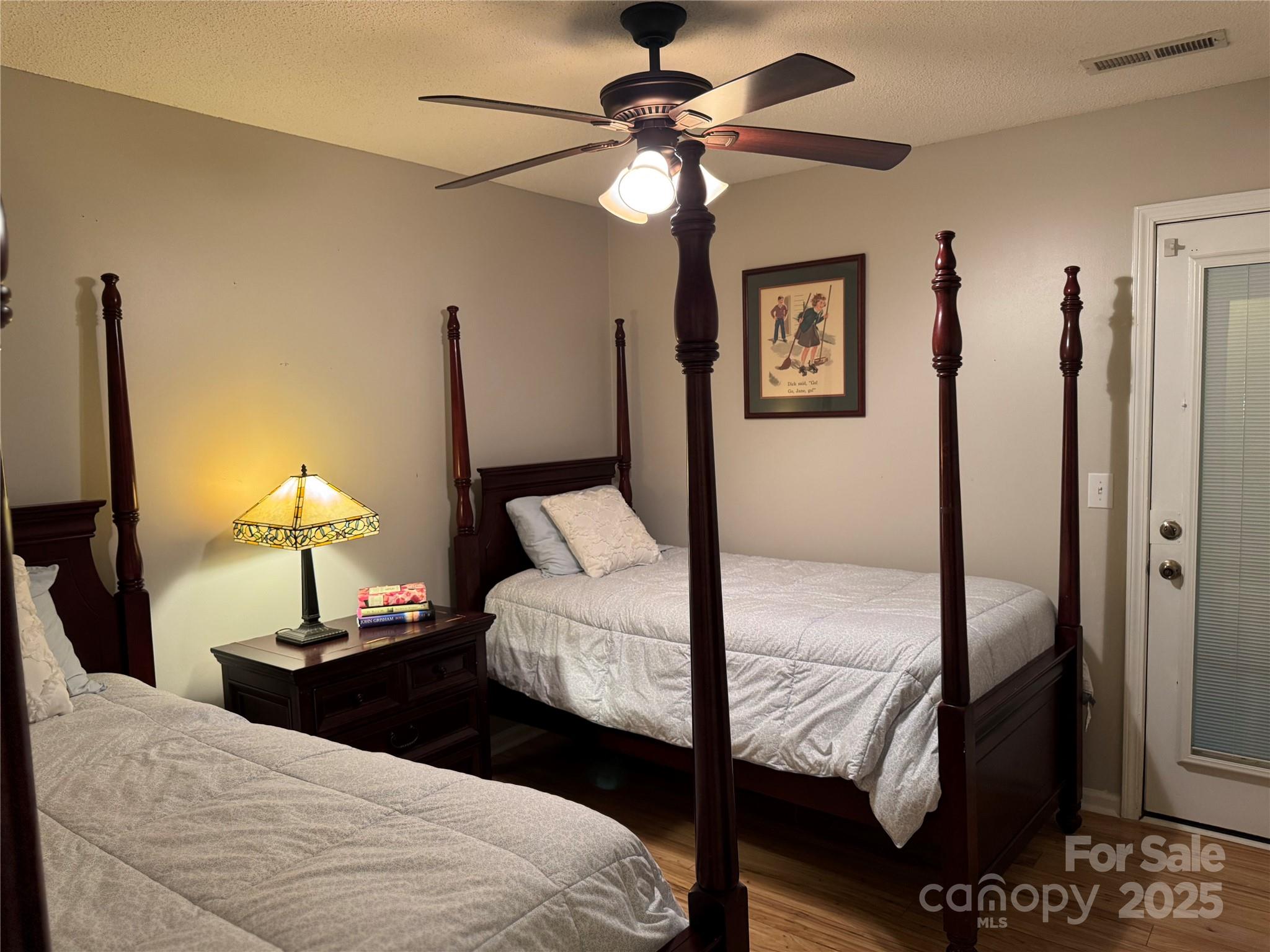 21120 Cold Spring Lane Cornelius, NC 28031 - Photo 16 of 22 a bedroom with a bed and a chandelier