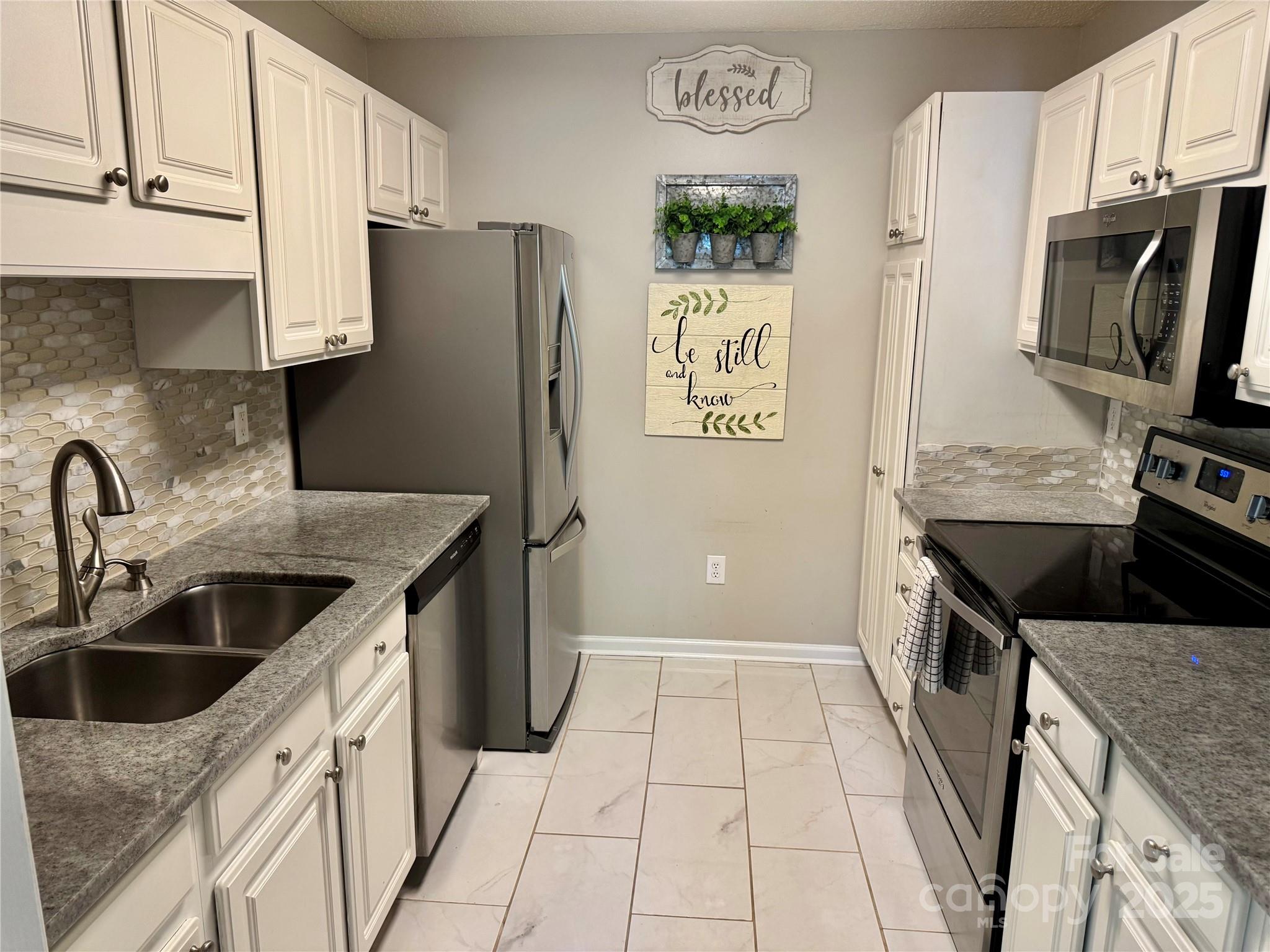 21120 Cold Spring Lane Cornelius, NC 28031 - Photo 9 of 22 a kitchen with stainless steel appliances granite countertop a refrigerator a stove a sink and dishwasher