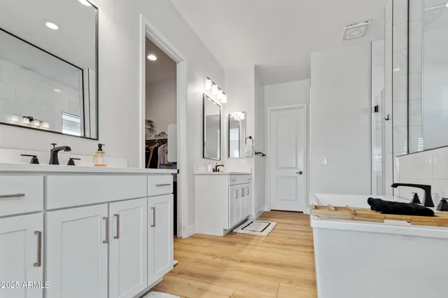 a spacious bedroom with a bed couch and window