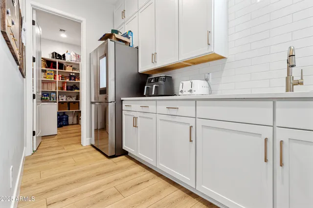 a kitchen with stainless steel appliances a refrigerator and cabinets