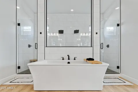 a spacious bathroom with a sink a mirror a vanity and a bathtub