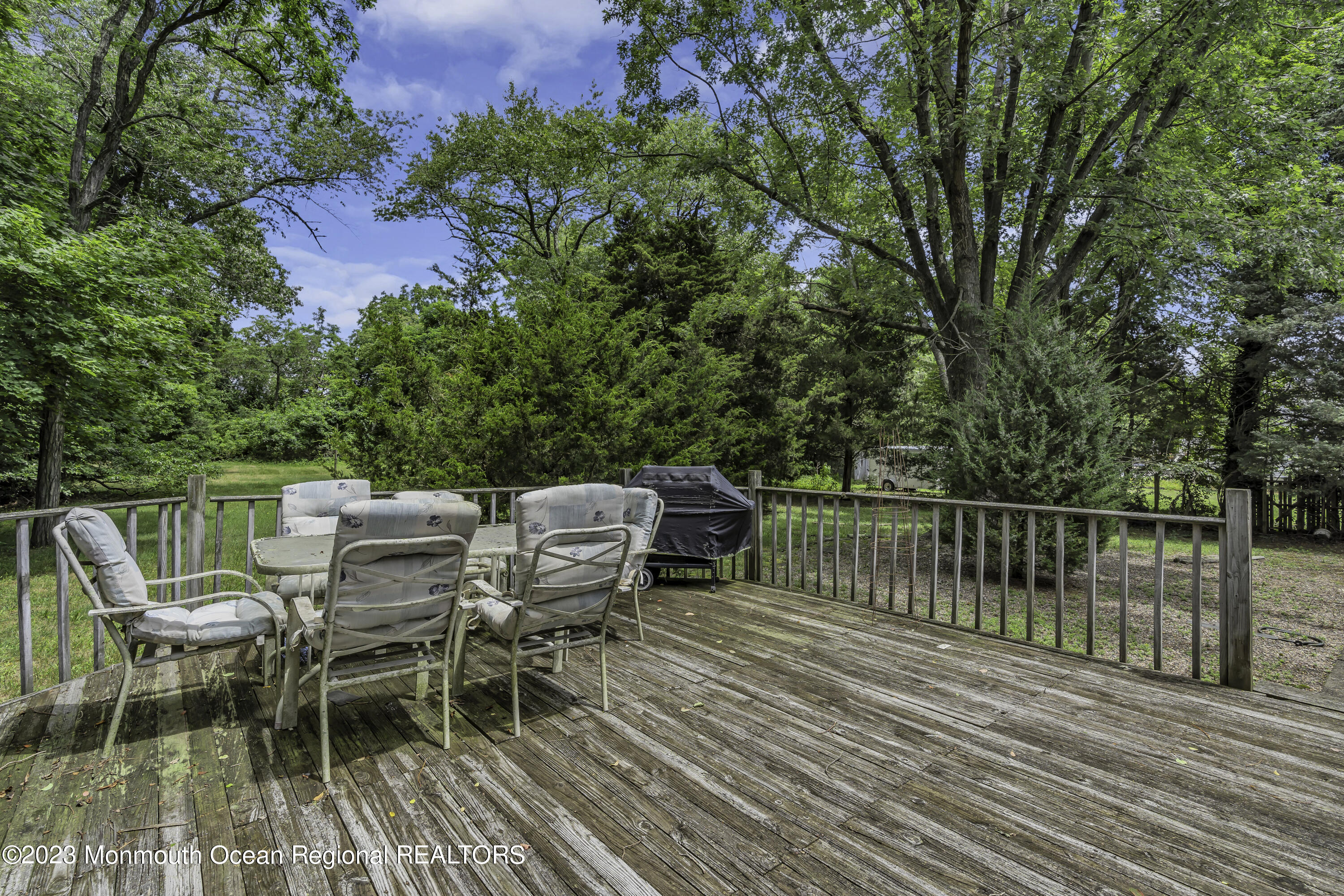 388 Cherry Quay Road Brick, NJ 08723 - Photo 30 of 35 a view of a roof deck with table and chairs and wooden floor