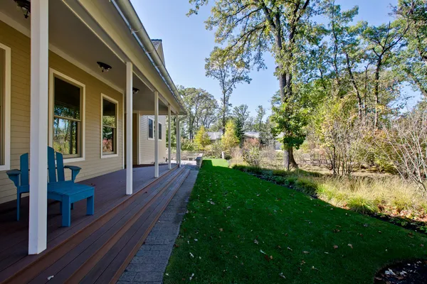 a view of a house with backyard and porch