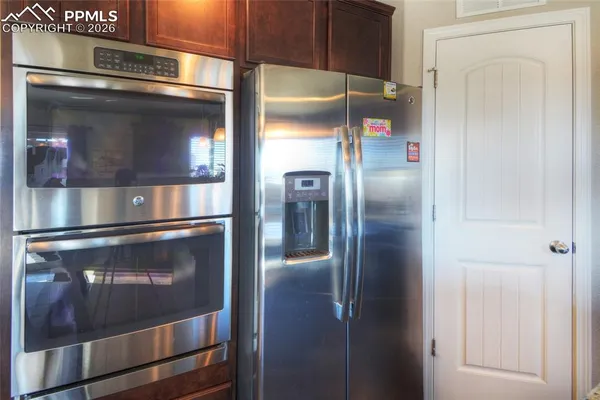 a view of a refrigerator in kitchen
