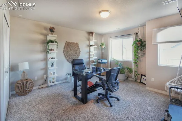 a view of a livingroom with furniture and a window