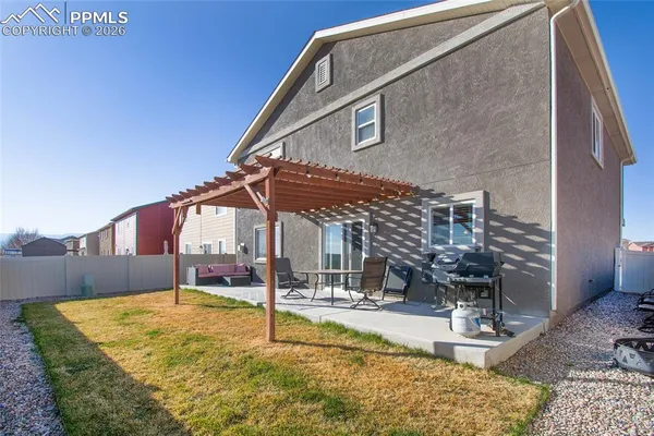 a view of a house with backyard and sitting area