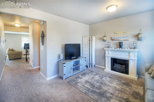 a living room with furniture and a fireplace