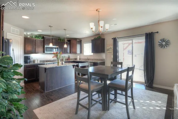 a kitchen with stainless steel appliances kitchen island granite countertop a sink and cabinets