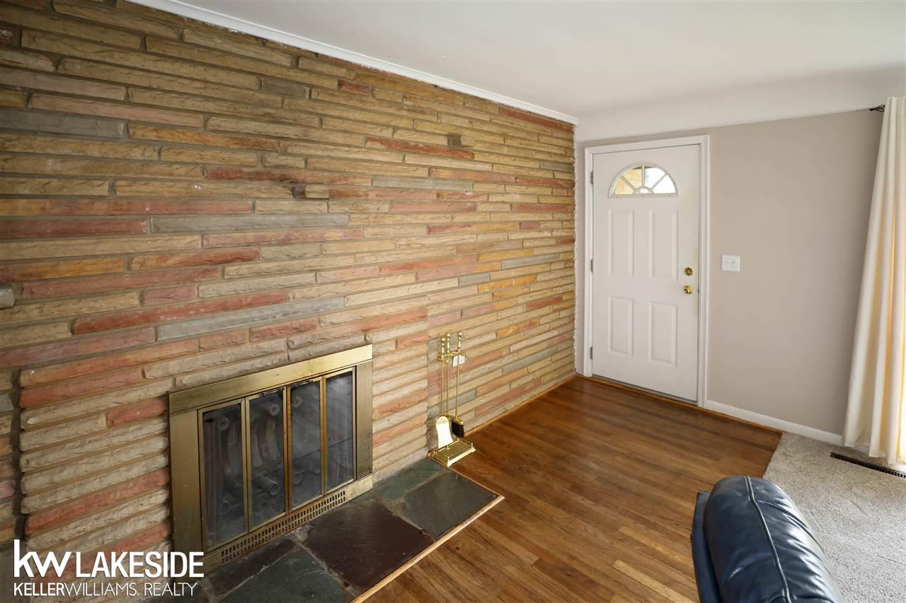 1515 East Hamlin Road Rochester, MI 48307 - Photo 14 of 31 Living room w/ natural fireplace, hardwood floors and huge window letting in plenty of light.