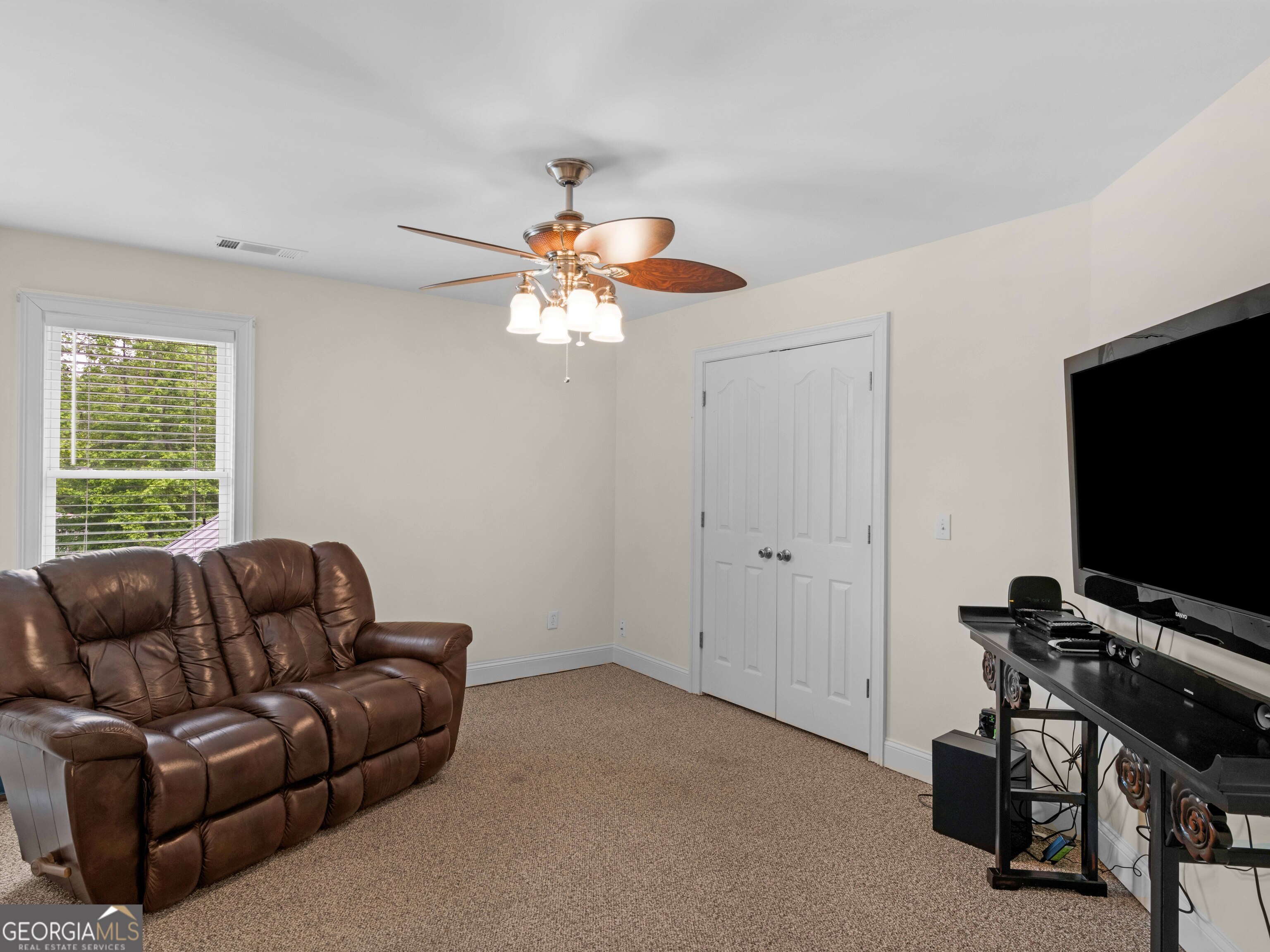 4101 West Ellis Road Griffin, GA 30223 - Photo 61 of 100 a living room with furniture a flat screen tv and a window