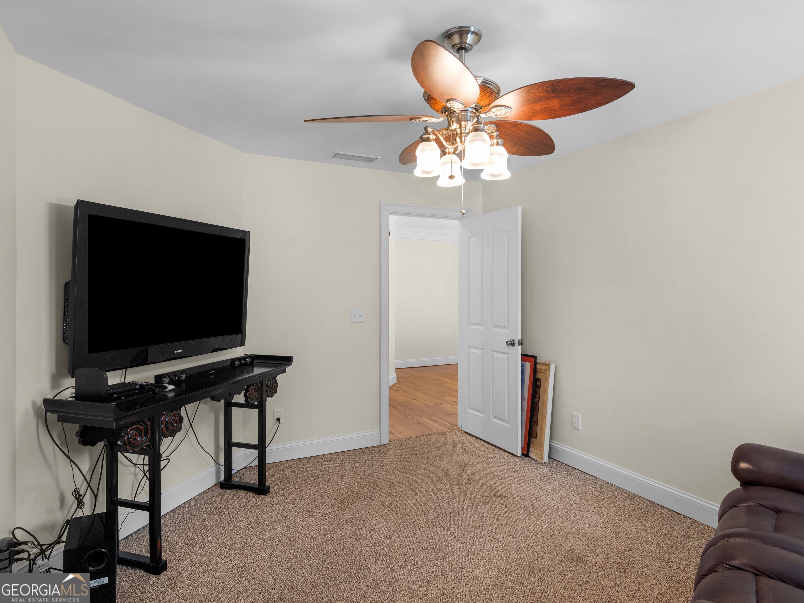 4101 West Ellis Road Griffin, GA 30223 - Photo 62 of 100 a living room with furniture and a flat screen tv