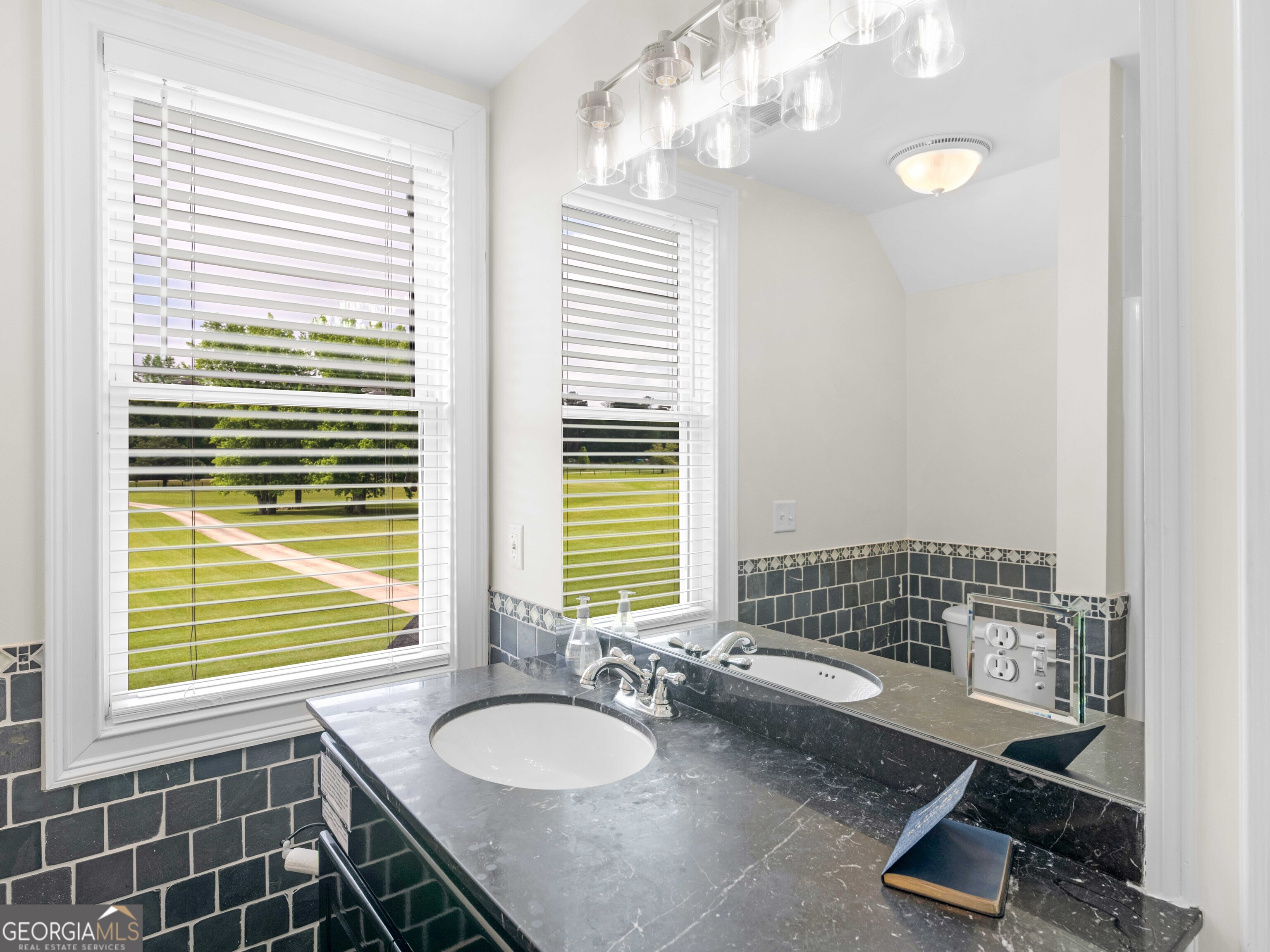 4101 West Ellis Road Griffin, GA 30223 - Photo 67 of 100 a bathroom with a granite countertop sink a toilet and a shower