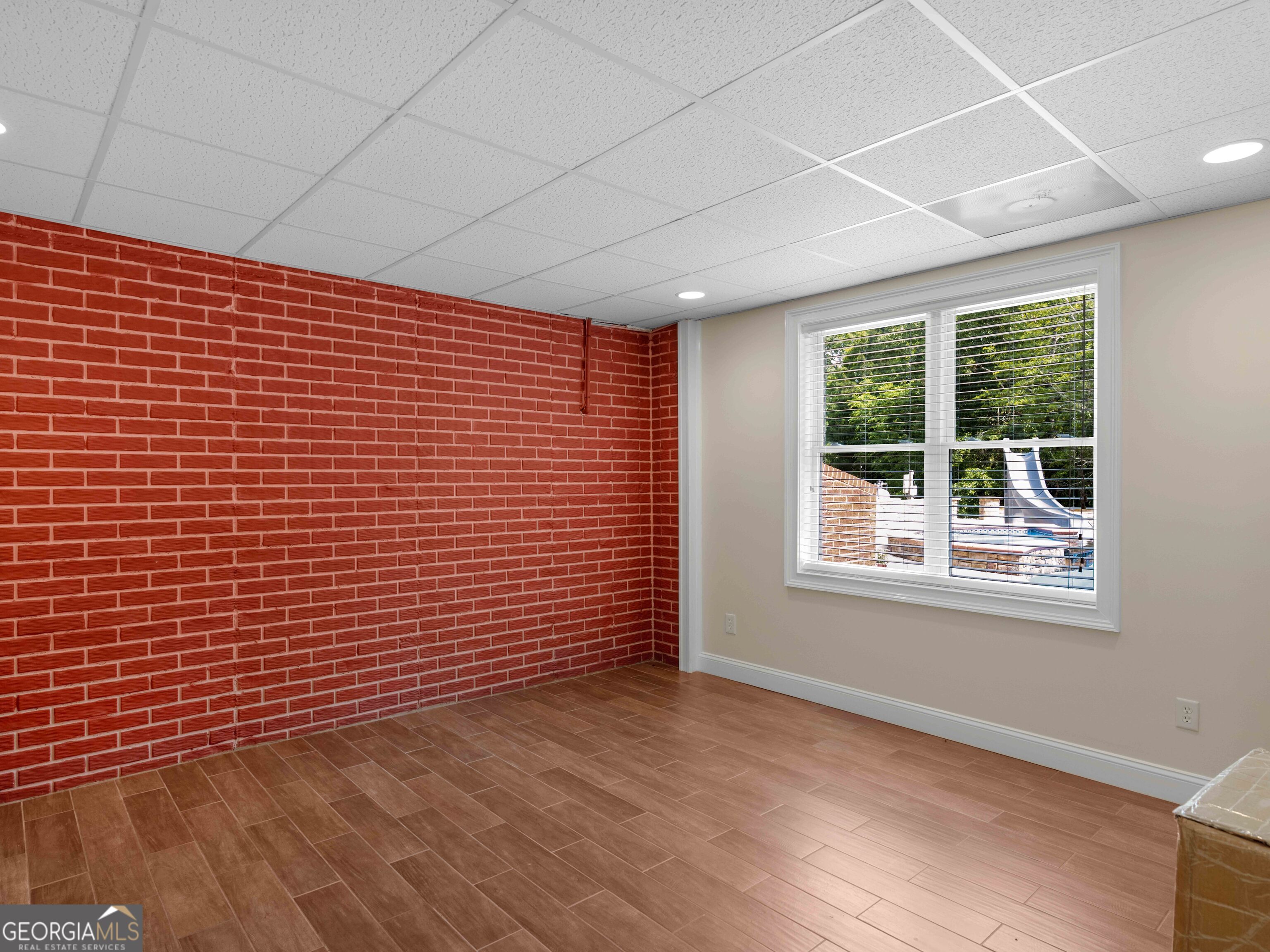 4101 West Ellis Road Griffin, GA 30223 - Photo 96 of 100 a view of an empty room with wooden floor and a window