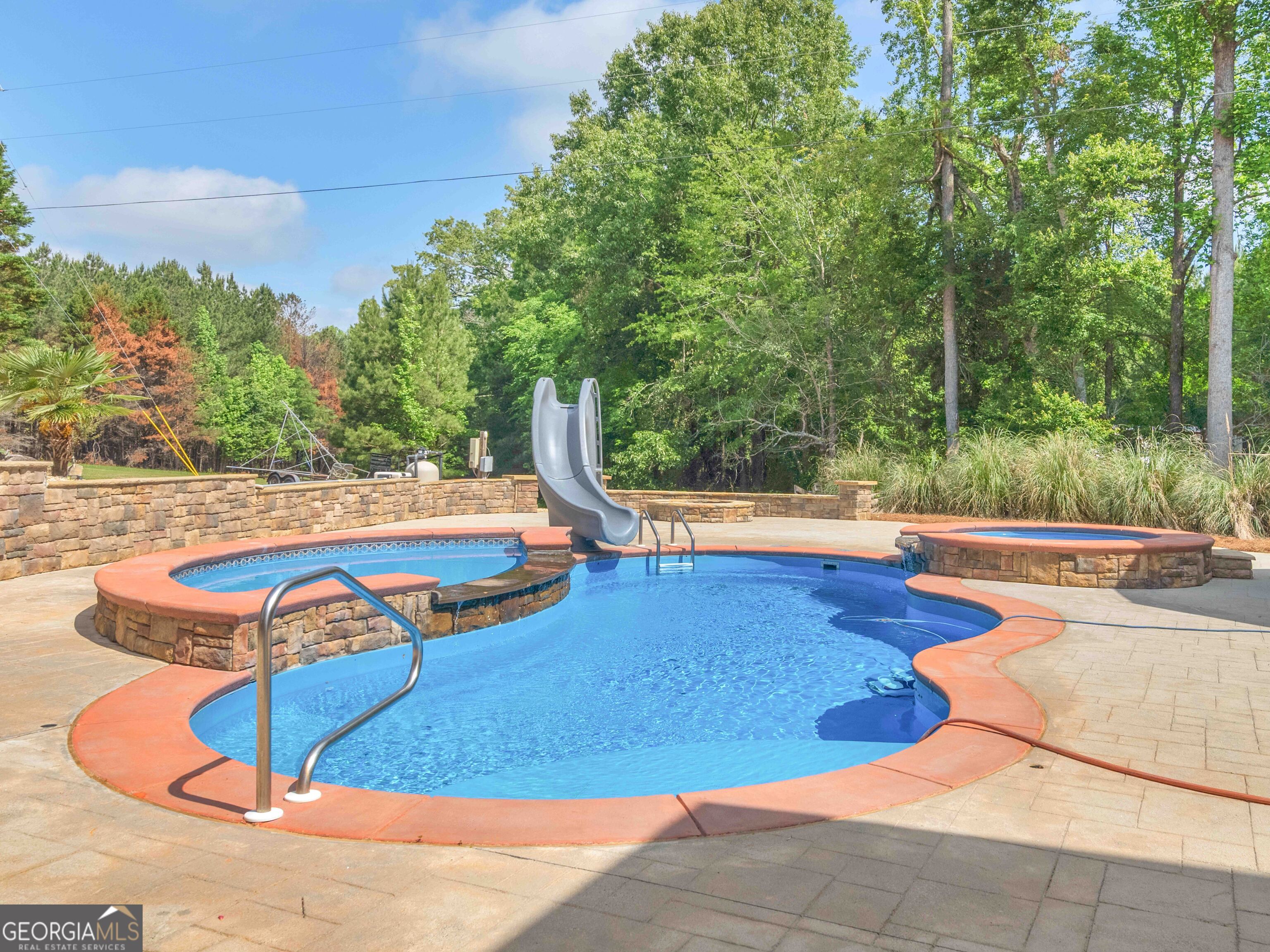 4101 West Ellis Road Griffin, GA 30223 - Photo 10 of 100 a view of a swimming pool with an outdoor space and seating area