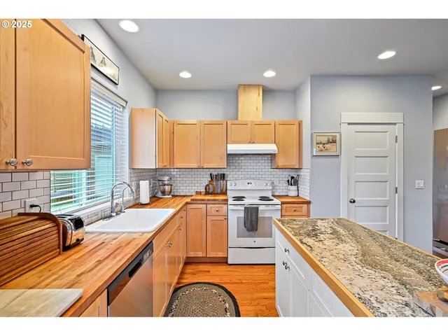 a kitchen with a stove a sink and a refrigerator