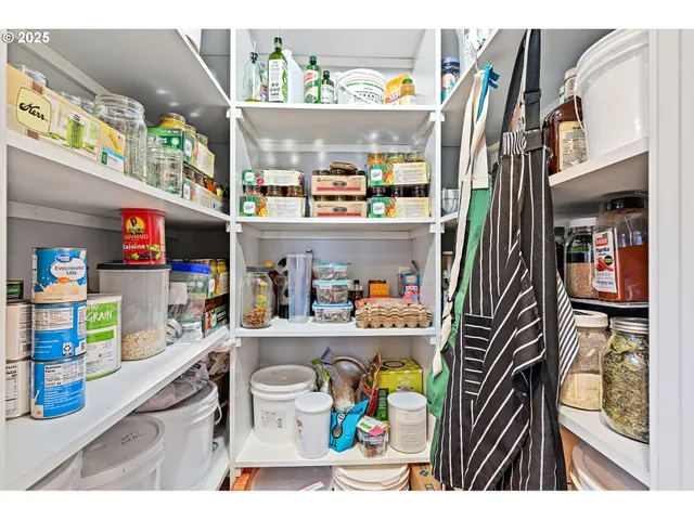 a utility room with lots of clutter and refrigerator