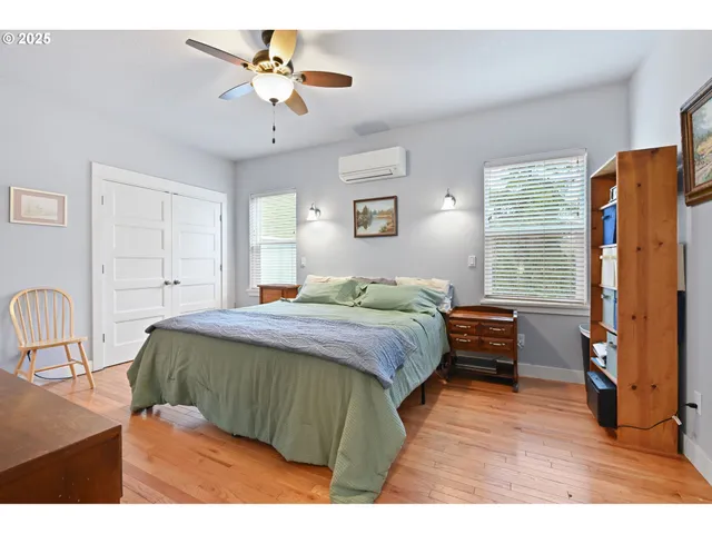 a bedroom with a bed dresser and a window