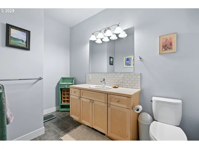 a bathroom with a sink a toilet and mirror