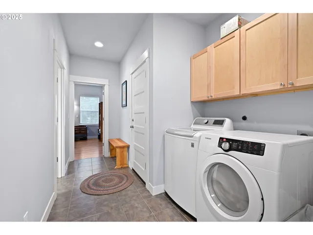 a view of a storage and utility room with washer and dryer