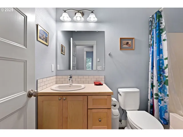 a bathroom with a sink a toilet and mirror
