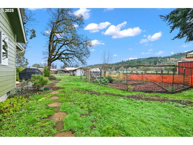 a view of a house with a yard and a garden