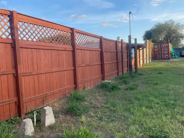 a view of a backyard with wooden fence