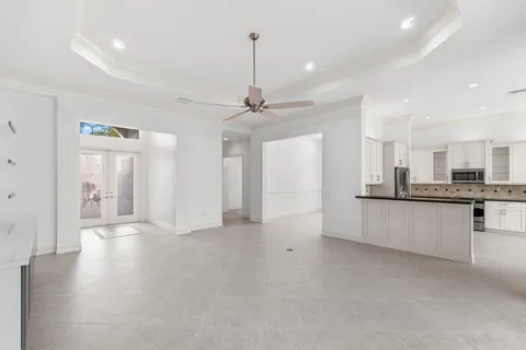 a view of a kitchen with refrigerator and a sink