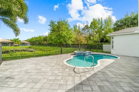 a view of a swimming pool with a yard