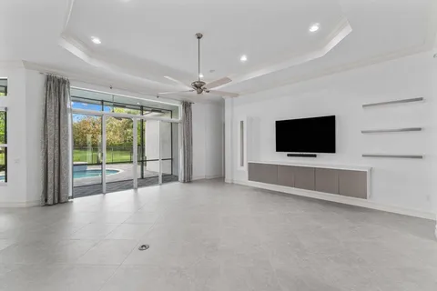 a view of an empty room with a flat screen tv and outdoor view