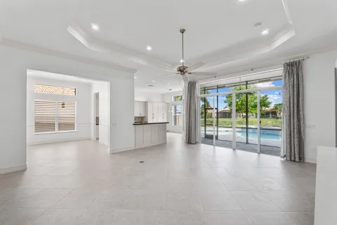 a view of an empty room with a sliding door and a window