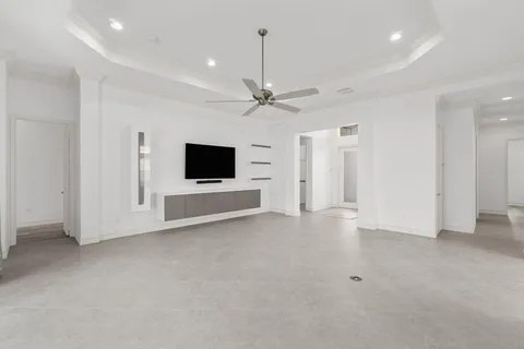 a view of an empty room with a ceiling fan