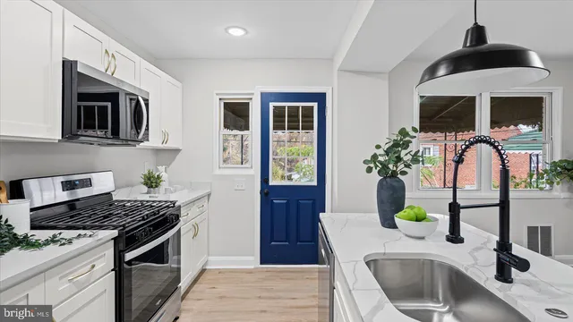 a kitchen with a sink stove and cabinets