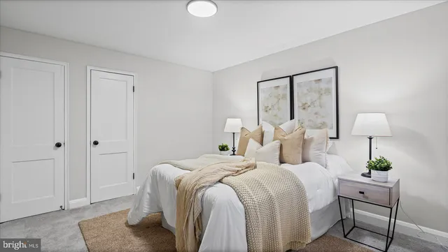 a bedroom with bed and a potted plant