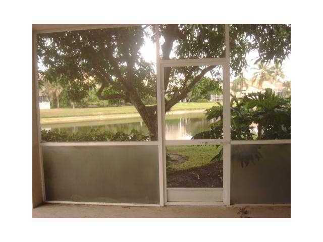 17196 Newport Club Drive Boca Raton, FL 33496 - Photo 15 of 22 Screened Porch leading to water view