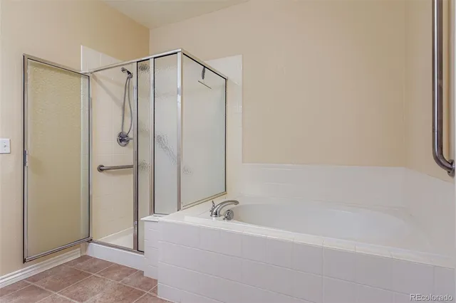 a bathroom with a tub and a shower
