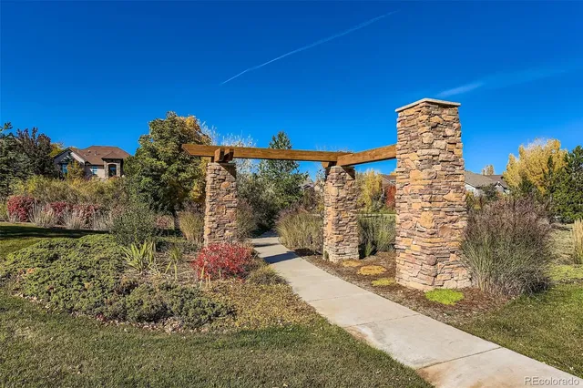 a view of a pathway with a wrought fence