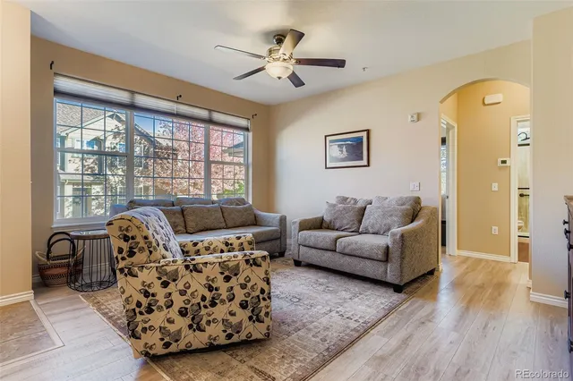 a living room with furniture and a large window