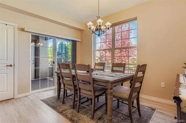 a view of a dining room with furniture wooden floor and chandelier