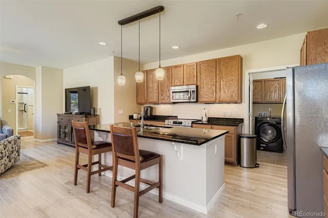 a kitchen with a stove a refrigerator and a sink